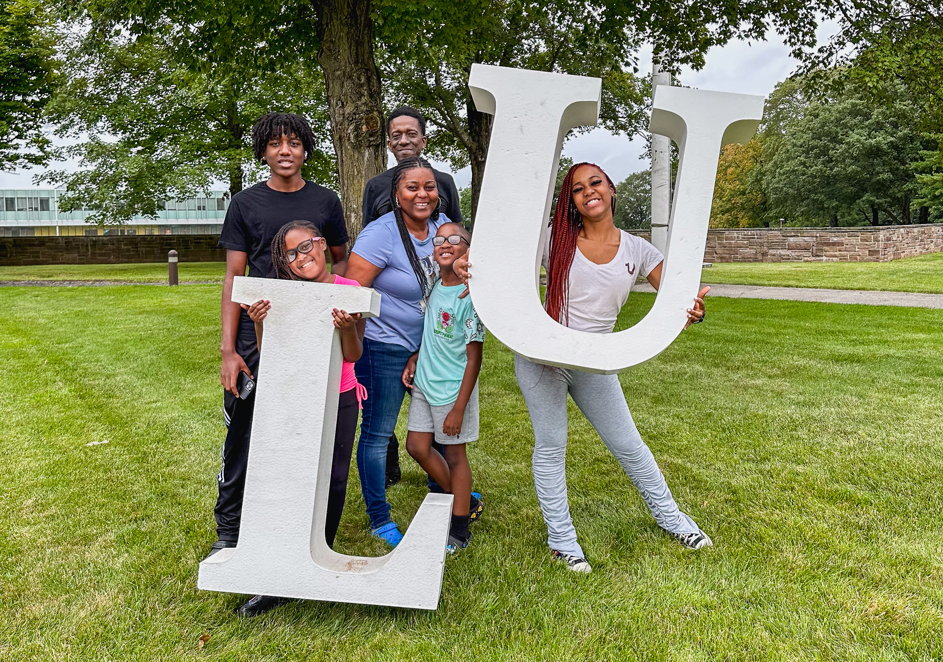 Family at Orientation Check-in holding large L and U letters