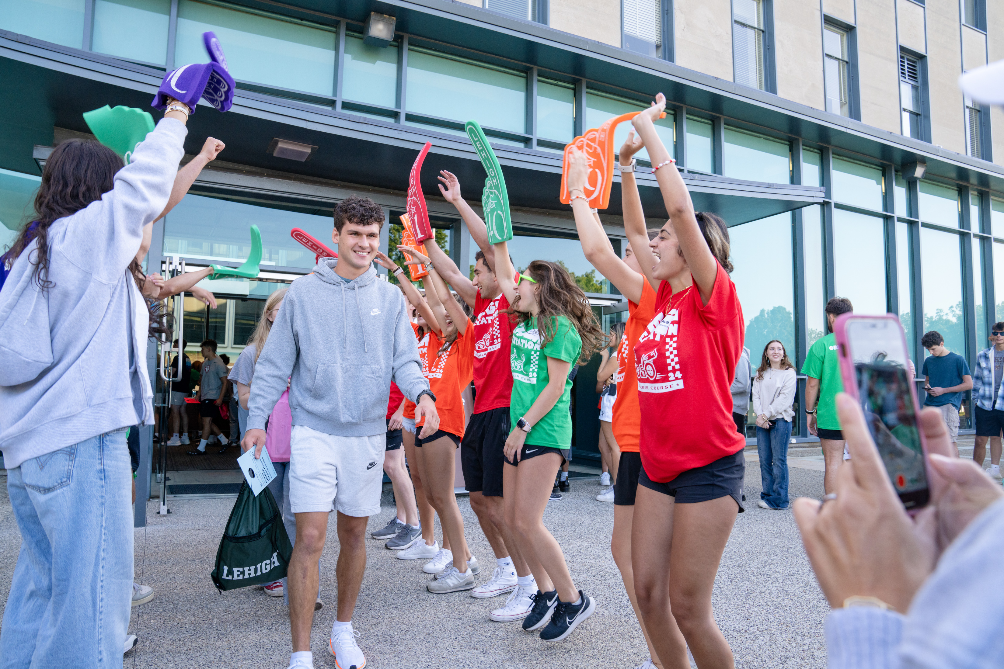 Orientation Leaders with foam fingers welcome students at check-in