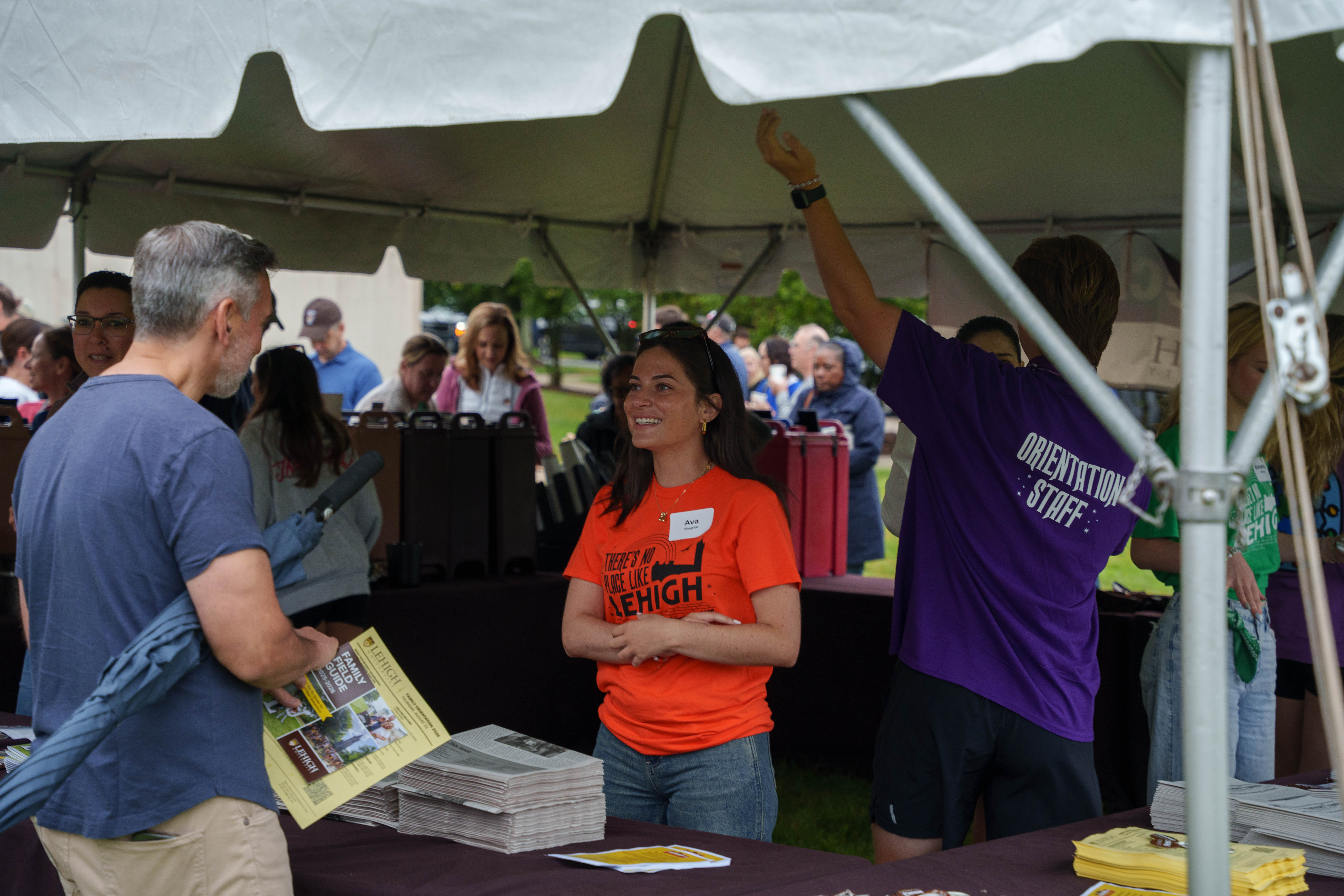 Orientation Leaders talking with families at check-in