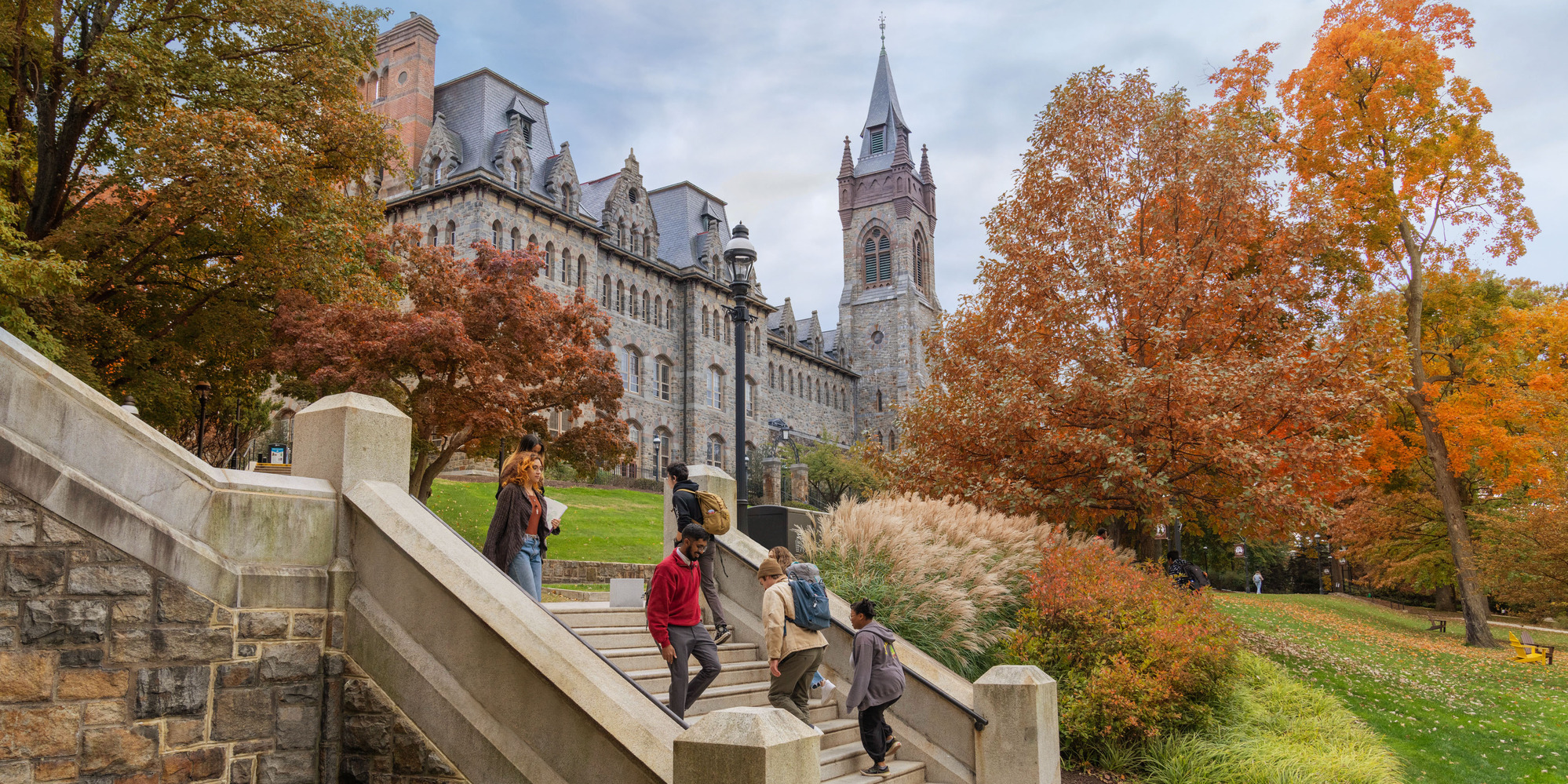 students walking down steps with Clayton UC in the background