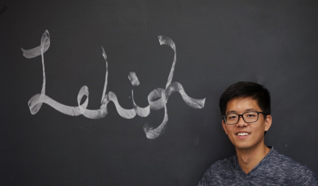 student in front of chalk board  with  the word Lehigh 