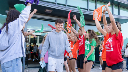 Orientation Leaders with foam fingers welcome students at check-in