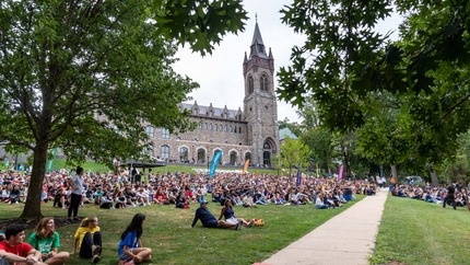 students sitting on the CUC front lawn for Orientation Kick-Off