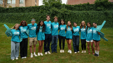 Orientation Leaders posing for a photo with foam fingers