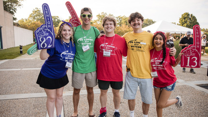 Orientation Leaders with colorful staff shirts and foam fingers