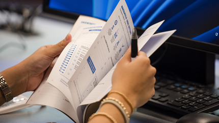 close up of daftbook in student's hands as they are flipping through