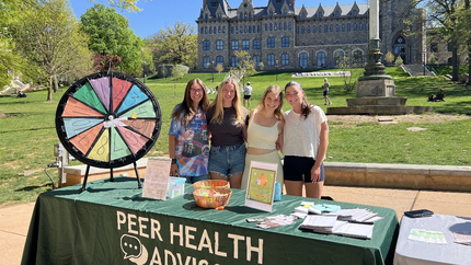 peer health advisors at a tabling in front of UC